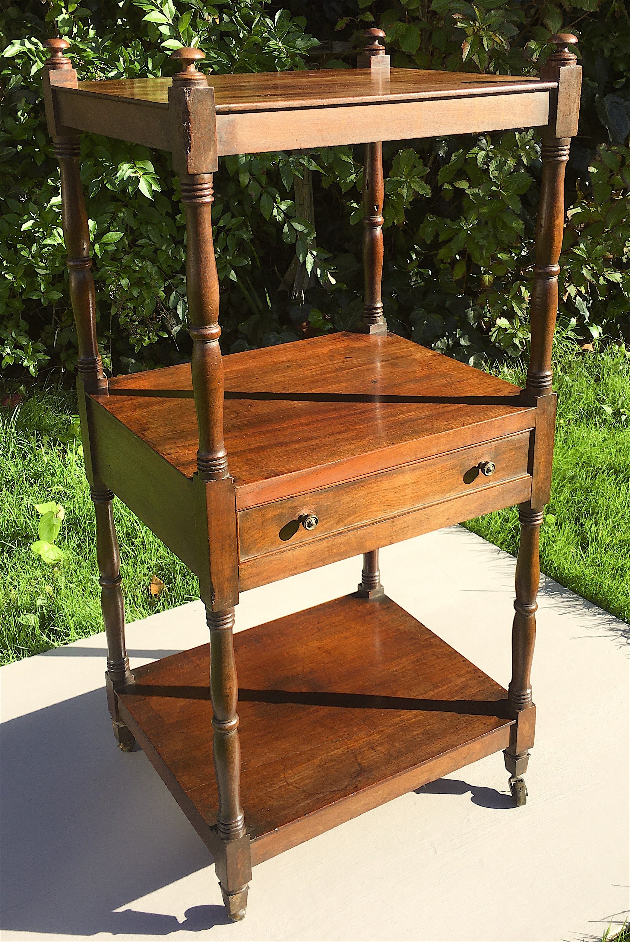 A Regency mahogany three tier whatnot fitted mid drawer, width 46cm, depth 38cm, height 98cm.